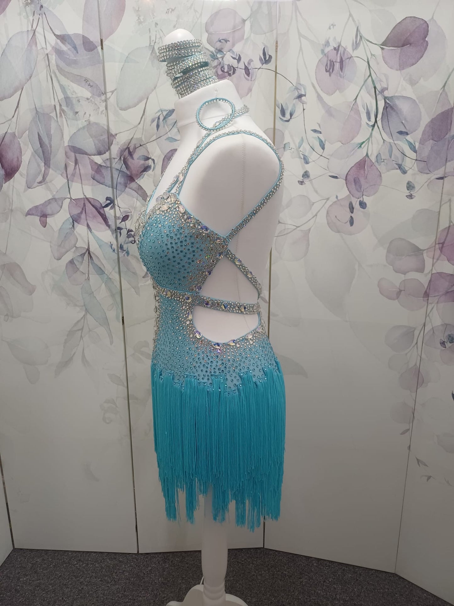 47L Paradise Blue Competition Latin Dance Dress. Beautiful detailing throughout with open design & strap details to the front. Comes with 8 bangles & matching Earrings. ❤️Showroom Appointments Available❤️
