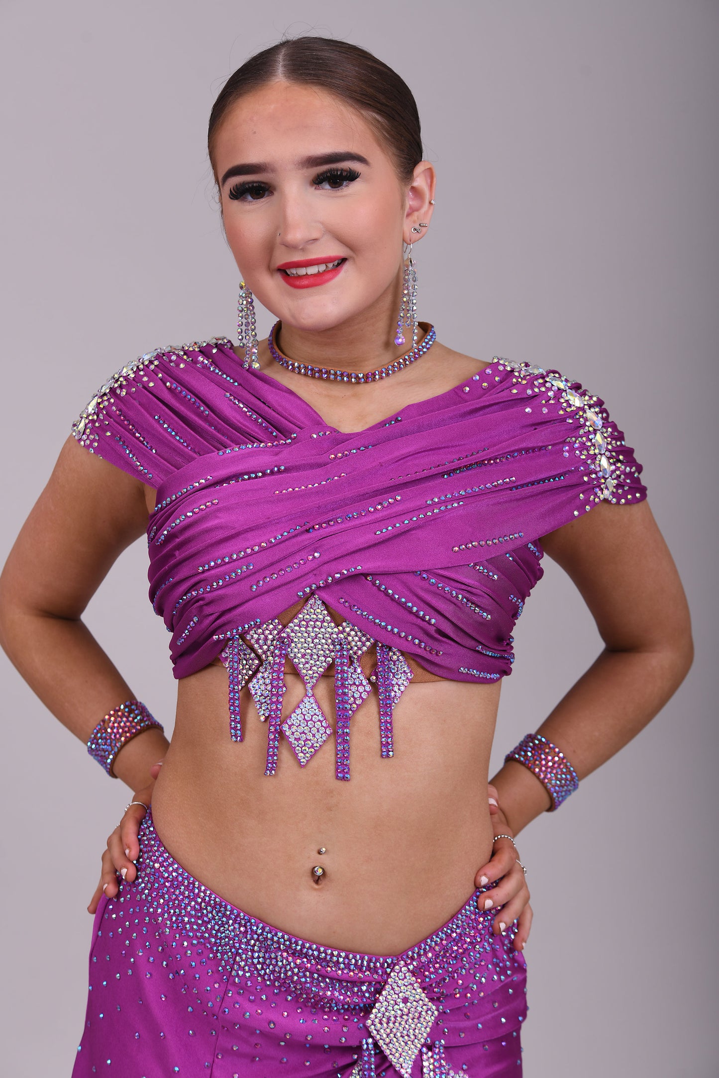 186 Stunning Latin 2 Piece. Full handkerchief skirt. Skirt comes with a choice of 2 tops. Stoned in Fuchsia AB & Fuchsia. Please add note at checkout choice of top required.