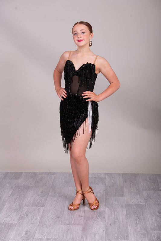 (BUDGET)12 Black Competition Latin Dance Dress. Heavily stoned bodice with beaded tassels. Mesh centre panel with corset details. Asymmetrical skirt stoned & full of beaded tassels. Open back with flesh security straps