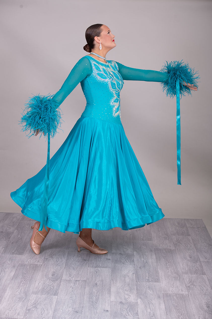 26B “TWD ELITE” Teal competition Ballroom/Sequence Dance dress. New Fuller skirts/Underskirts with 3D design to front and back. Stoned in AB & Blue Zircon. Detachable Ostrich Feather Floats