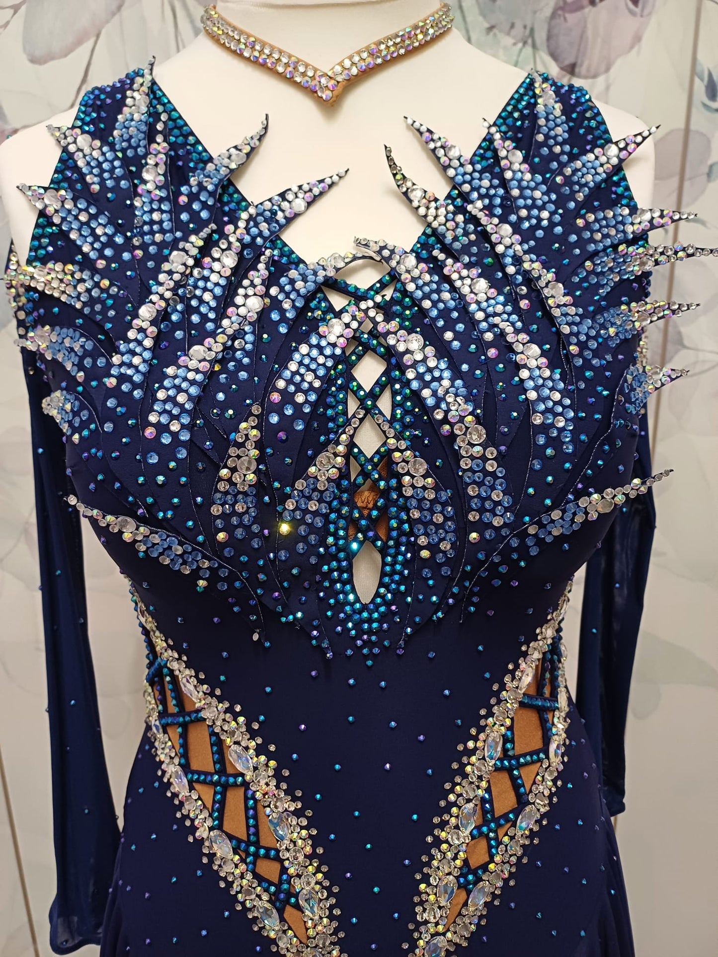 12L Navy Blue Competition Latin/Rhythm Dress. 3D Design to upper chest with flattering detailing to Hips. High back giving option to wear own Bra. Stoned in Blue, Blue AB & AB