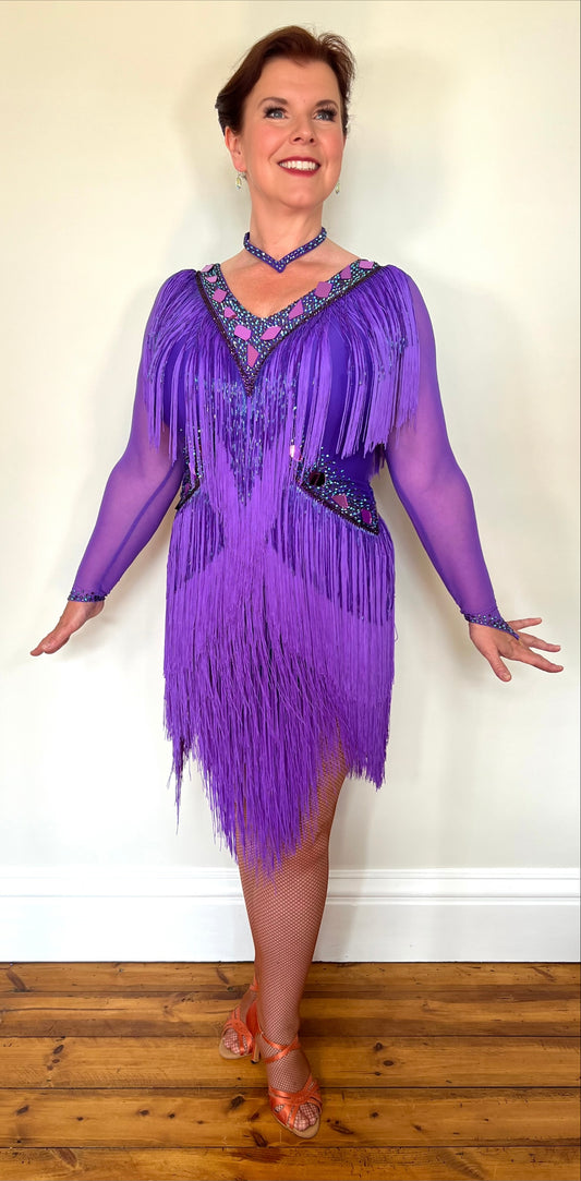 181 Purple Latin Dance Dress. Very full layered fringe. Decorated with purple mirrors, purple bead droppers and purple ab stones. High back to give option for wearing own bra.