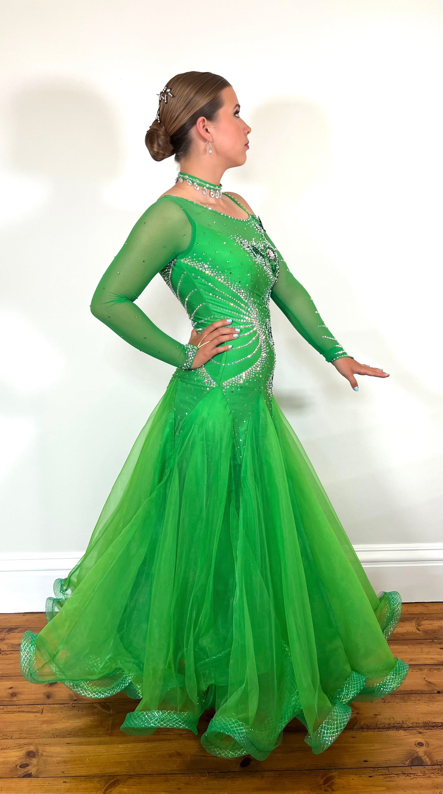 010 Apple Green one Shoulder, one cold shoulder Ballroom Dress. Appliqué stoned in AB & Jade to one side of the bodice.