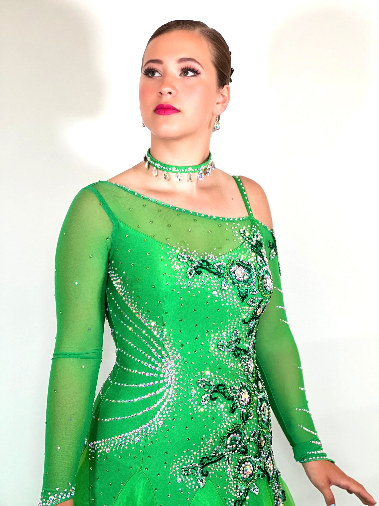 010 Apple Green one Shoulder, one cold shoulder Ballroom Dress. Appliqué stoned in AB & Jade to one side of the bodice.