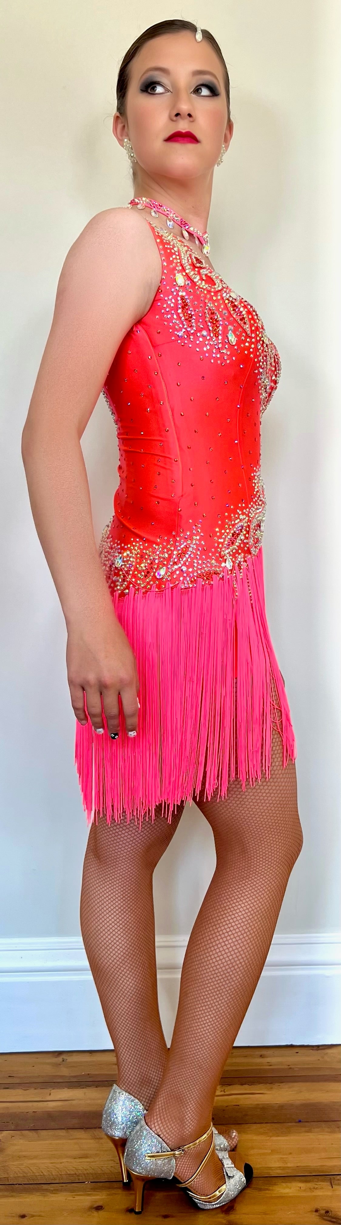 104 Coral Fringe Skirt Latin Dress. Full fringe skirt with bodice decorated in Coral appliqué and stoned in AB & Hyacinth