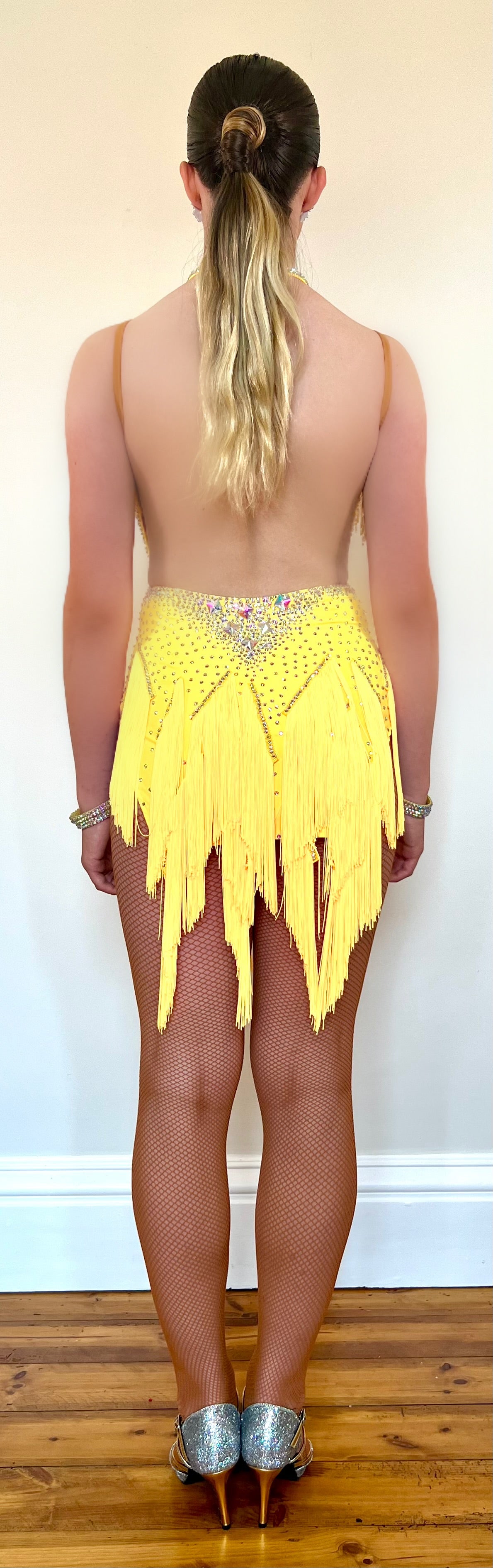 260 Yellow Fringe detailed skirt Latin Dress. AB stones with golden droppers to the chest. Open detailing to the front.
