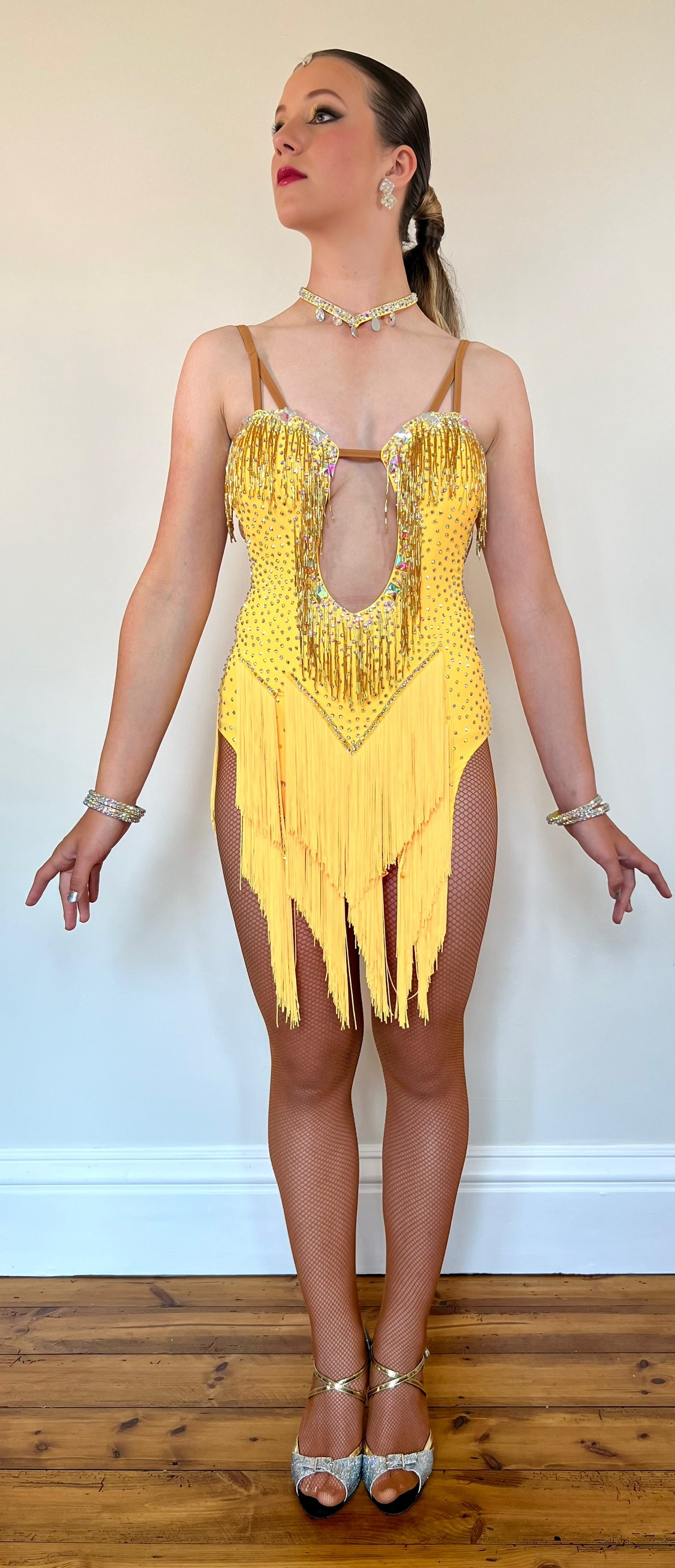 260 Yellow Fringe detailed skirt Latin Dress. AB stones with golden droppers to the chest. Open detailing to the front.