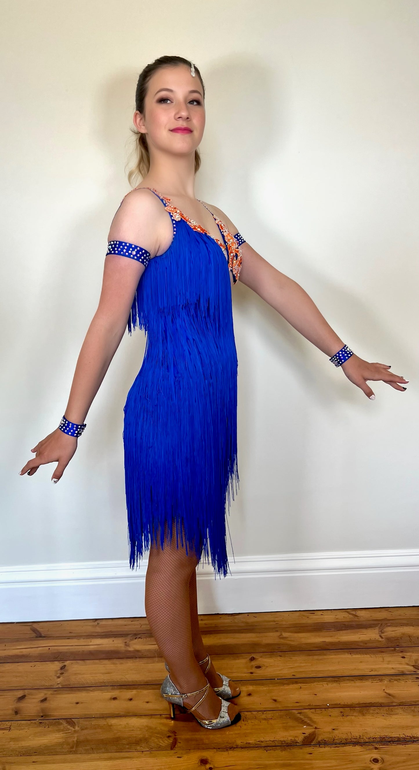 108 Bright Royal Blue & Orange strap Detail Latin Dress decorated with orange appliqué AB & sapphire stones. Fringing to the right side and skirt.