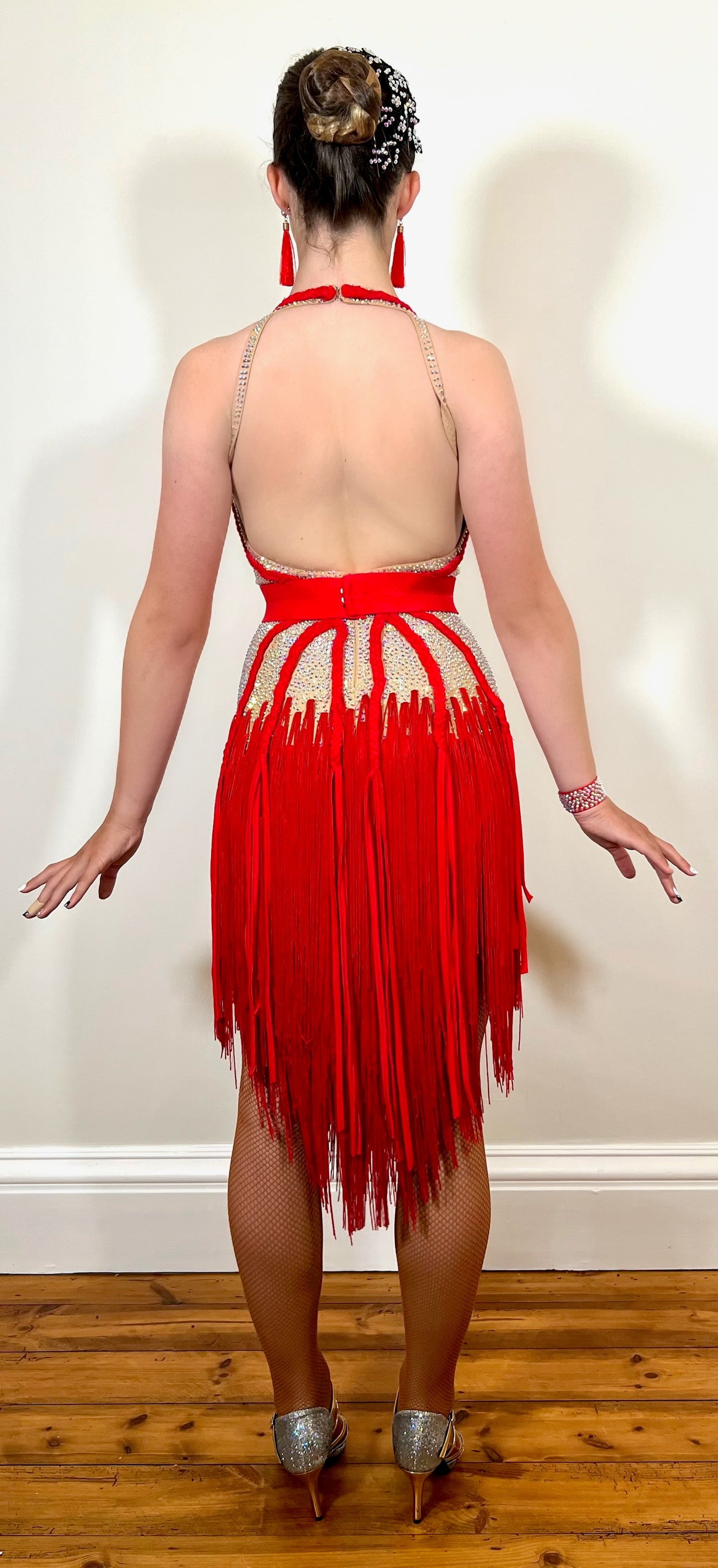 103 Red & Flesh Material Fringe Latin Dress. AB stoned bodice on flesh leotard. Plaited fabric design with detachable belt.