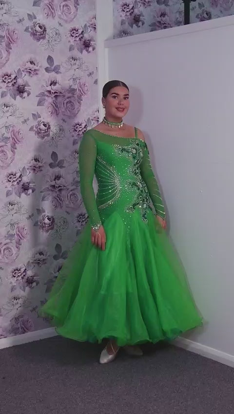 010 Apple Green one Shoulder, one cold shoulder Ballroom Dress. Appliqué stoned in AB & Jade to one side of the bodice.