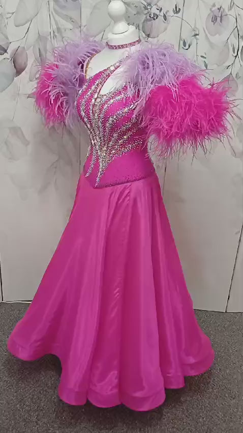 005 Cerise Pink Competition Ballroom Dance Dress. Heavily stoned in AB and Fuchsia & lilac. Comes with ostrich cuffs in Lilac & Cerise. Beautiful back detail.