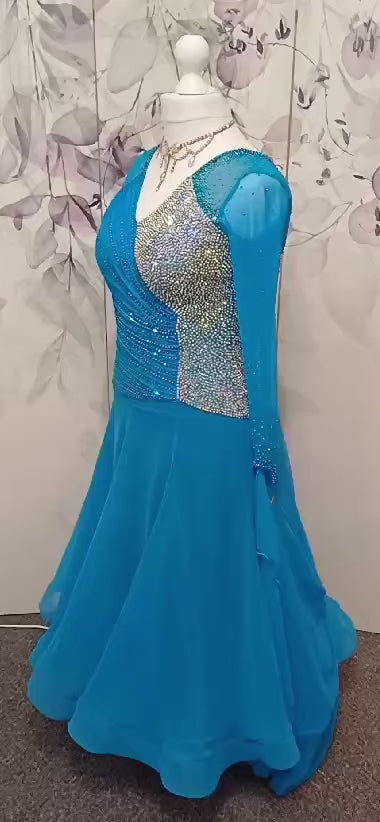 092 Turquoise Competition Ballroom Dance Dress heavily stoned in AB to half of the front and back bodice. Rouched detailing to the right side bodice stoned in Capri Blue. High back to give option of wearing own bra with small keyhole detailing.