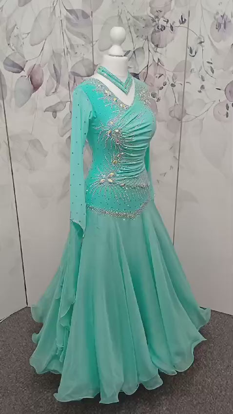 051. Stunning Mint Green Competition Ballroom Dance Dress. Heavily stoned in AB with Mesh detailing to the front. Detachable floats