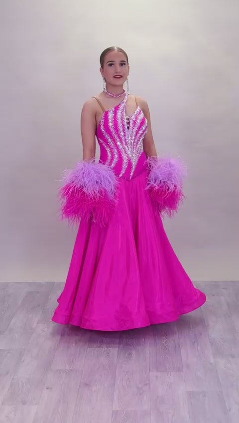 005 Cerise Pink Competition Ballroom Dance Dress. Heavily stoned in AB and Fuchsia & lilac. Comes with ostrich cuffs in Lilac & Cerise. Beautiful back detail.