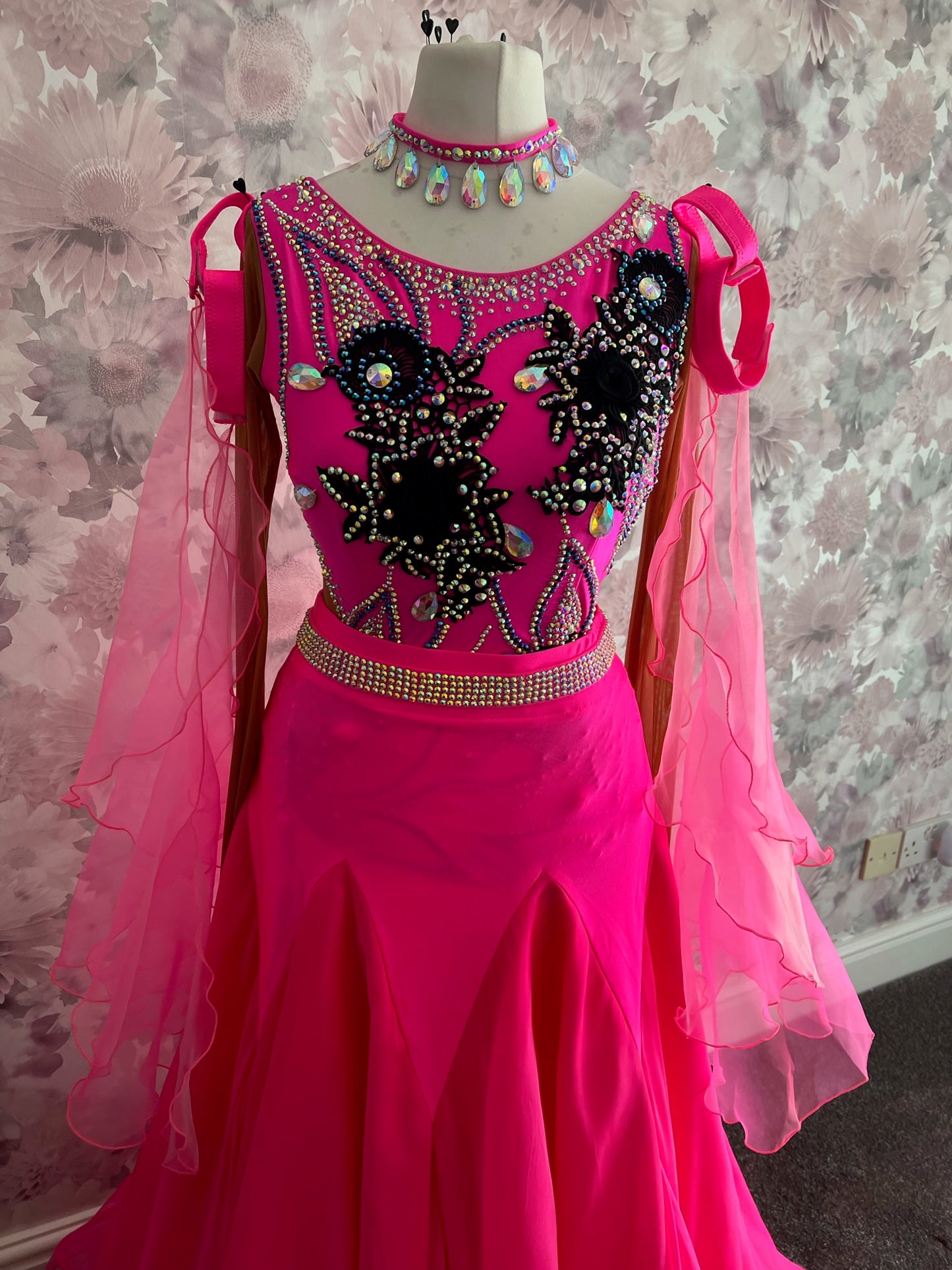 014 Flo Pink Latin dress with black appliqué. Decorated with AB & Light Rose stones with full fringed skirt. Ballroom Skirt & x4 arm floats plus AB stoned belt